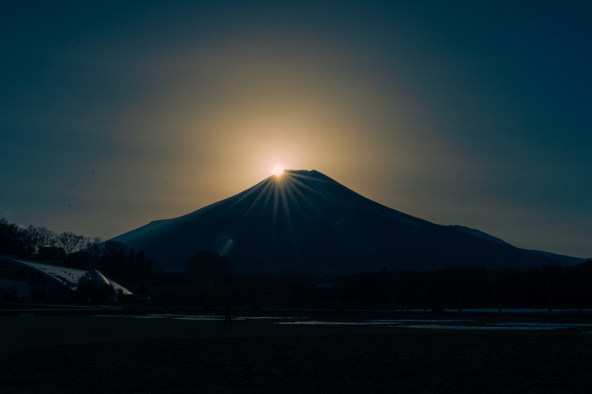 The sun cresting the summit of Mt Fuji